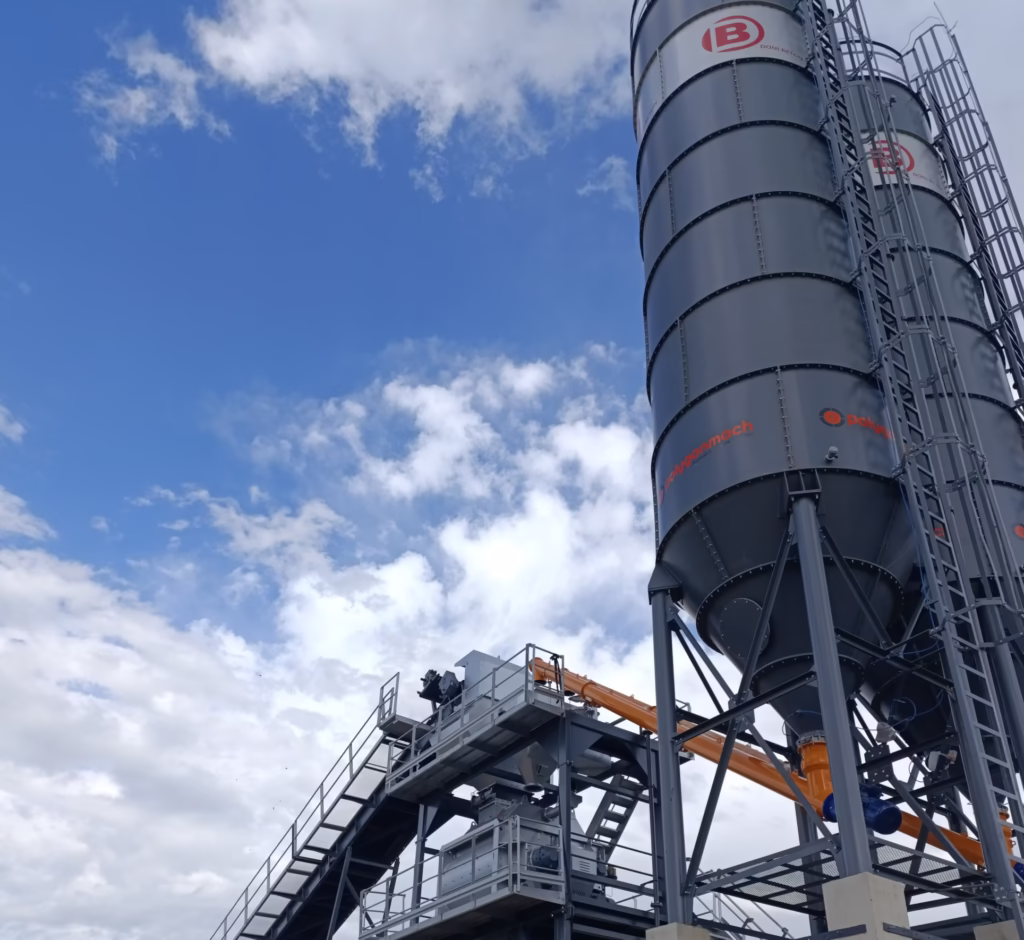Twin vertical cement silos designed by Polygon Machine for continuous cement storage in stationary concrete batching plants