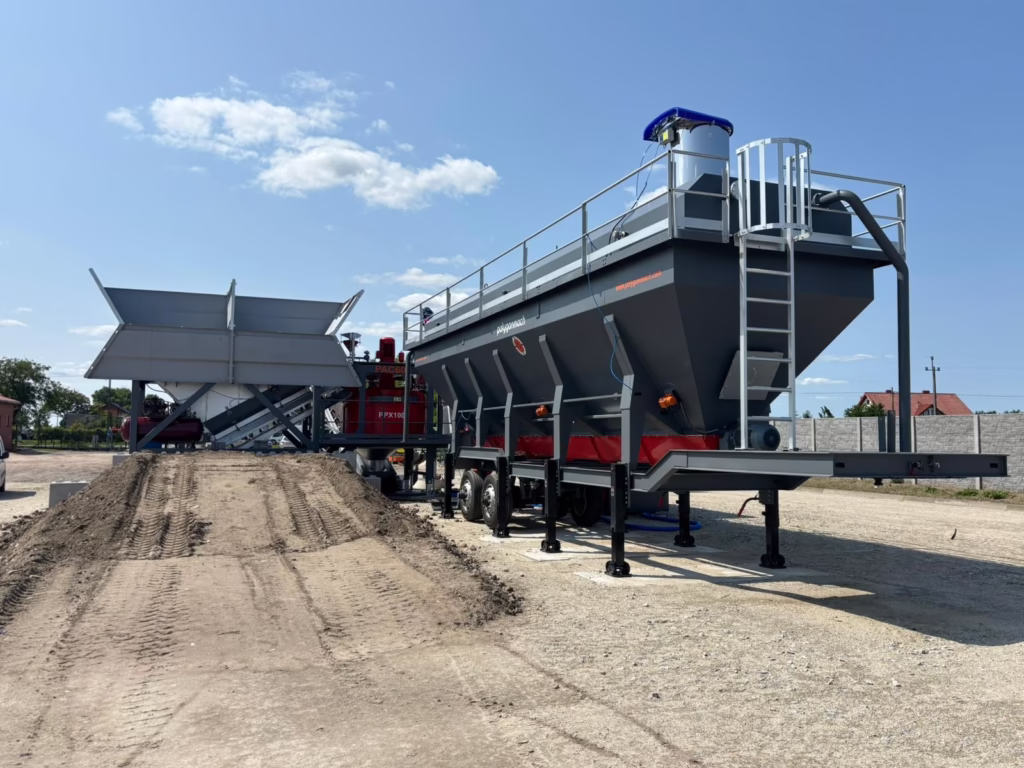 Mobile concrete batching plant with trailer-mounted aggregate hopper and mixer unit, ready for on-site operation.